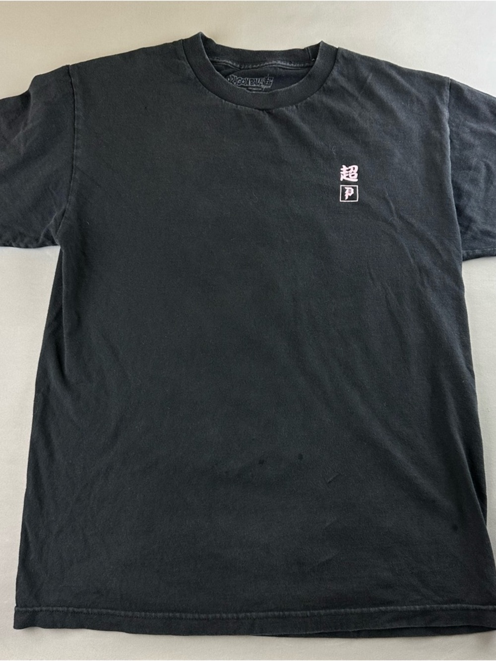 Primitive Black Short-Sleeve Tee with Small Pink Chest Graphic